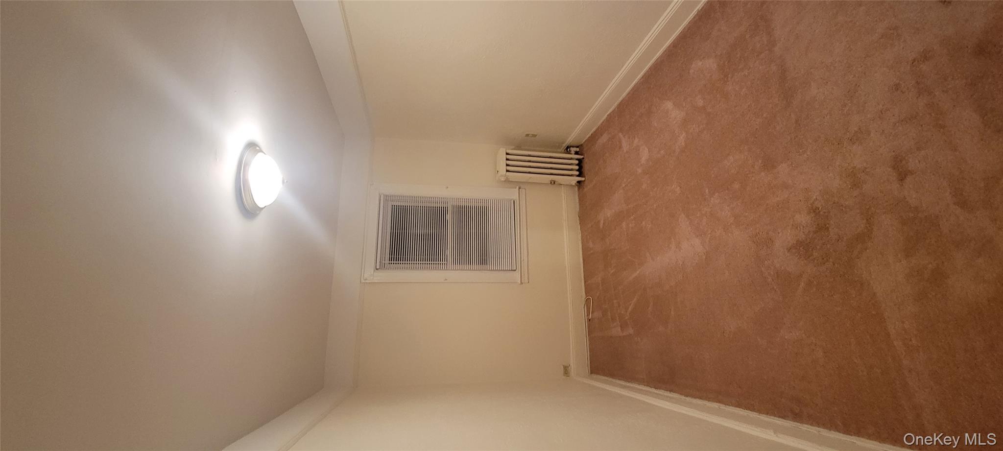 31-22 100th Street, Unit 2 Queens, NY 11369 - Photo 9 of 11 an empty room with a empty space and windows