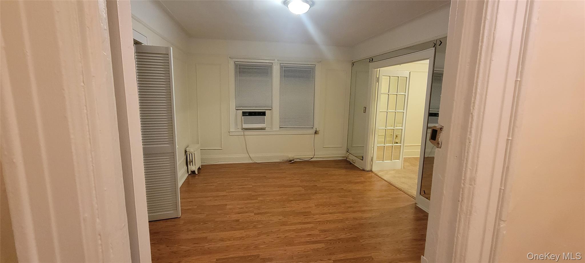 31-22 100th Street, Unit 2 Queens, NY 11369 - Photo 10 of 11 a view of an empty room with windows