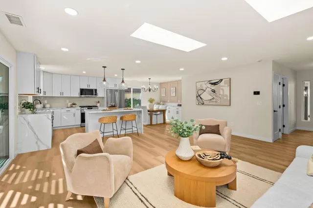 a living room with furniture and kitchen view