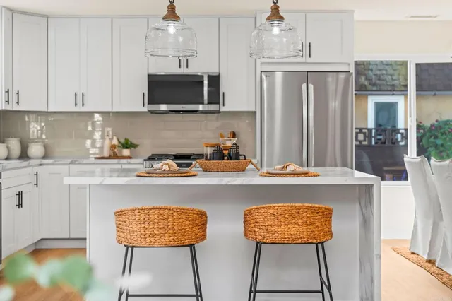 a kitchen with stainless steel appliances a stove refrigerator sink and cabinets