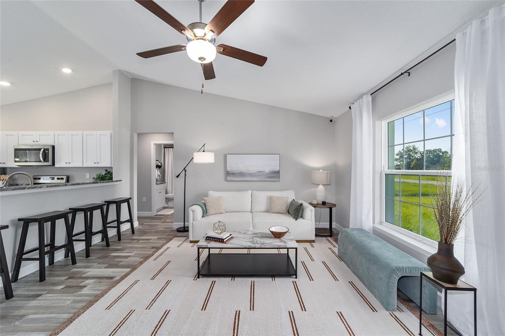 8571 Southwest 131st Place Ocala, FL 34473 - Photo 6 of 32 a living room with furniture a fireplace and a table