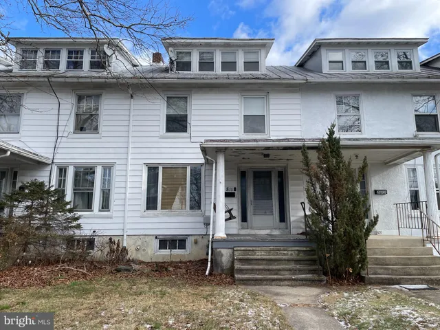 a view of a white building with large windows