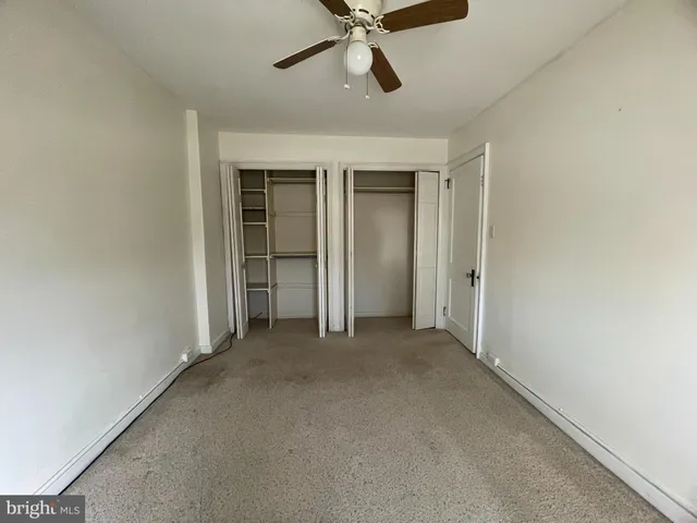 an empty room and chandelier fan