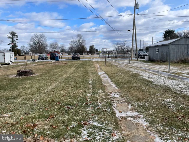 a view of yard with cars