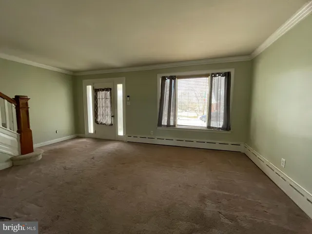 an empty room with a empty space and windows