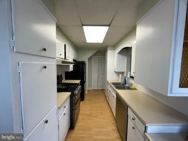 a kitchen with stainless steel appliances a sink and a refrigerator
