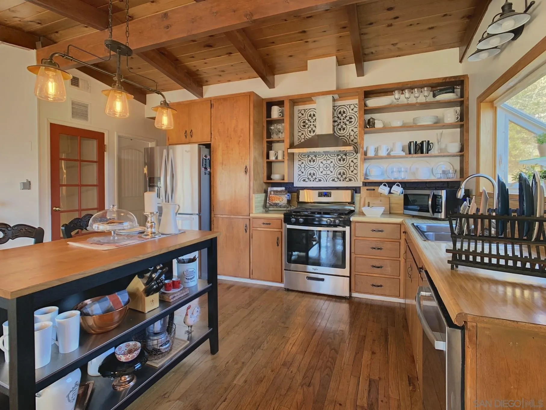 34642 Navajo Road Julian, CA 92036 - Photo 13 of 32 a kitchen with stainless steel appliances a stove a refrigerator and wooden cabinets
