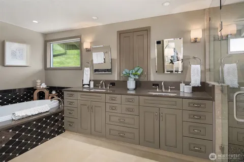 a bathroom with a granite countertop sink a mirror and shower