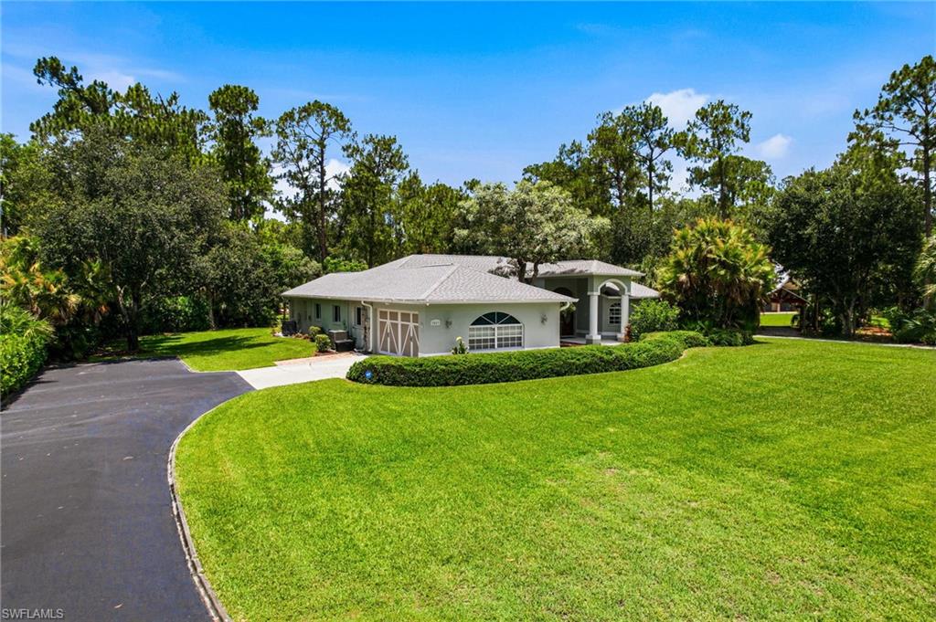 2053 17th Street Southwest Naples, FL 34117 - Photo 1 of 47 a view of a house with a yard
