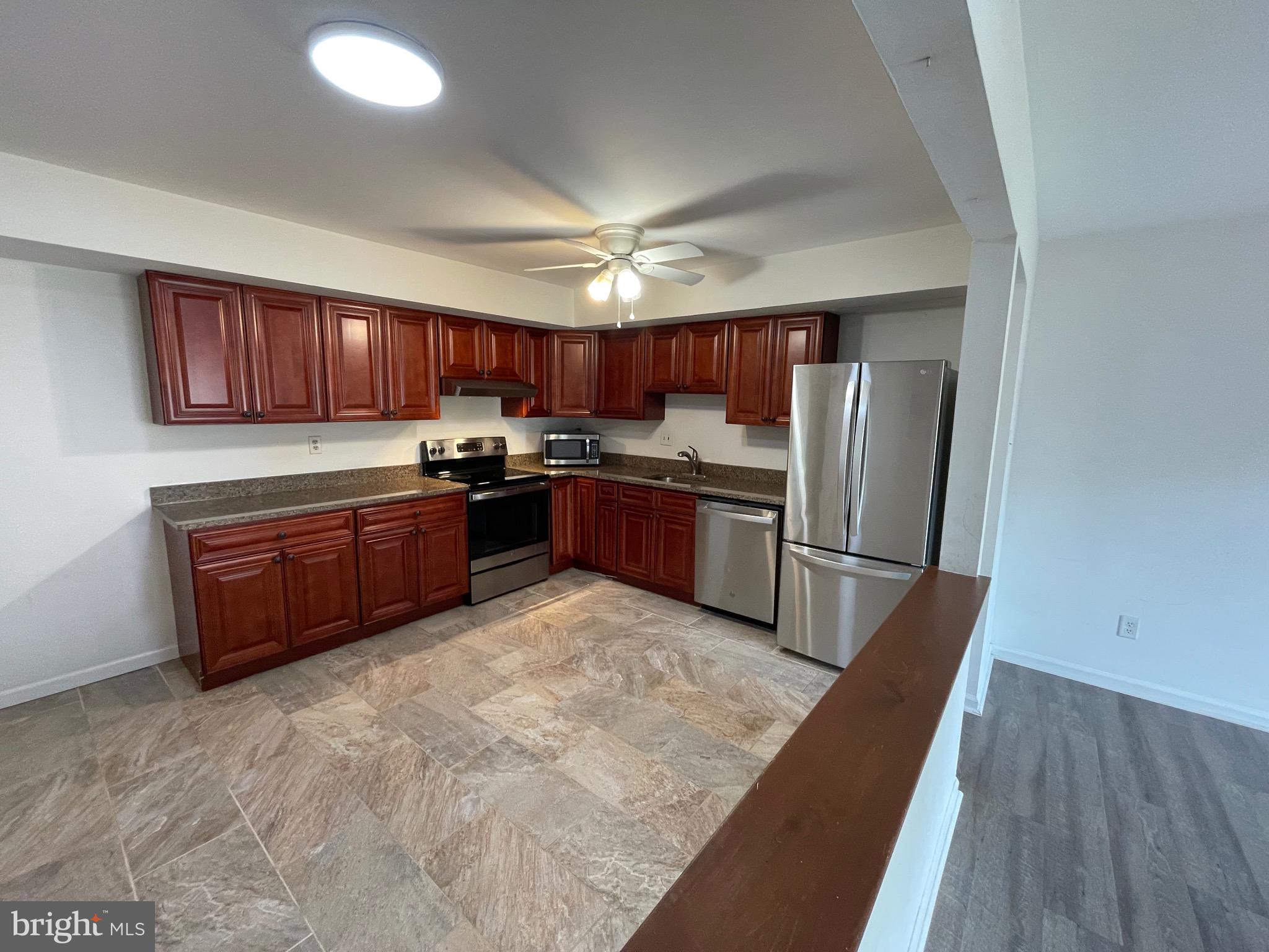 3314 Roxbury Road Hatfield, PA 19440 - Photo 11 of 26 a kitchen with stainless steel appliances granite countertop a refrigerator sink and cabinets