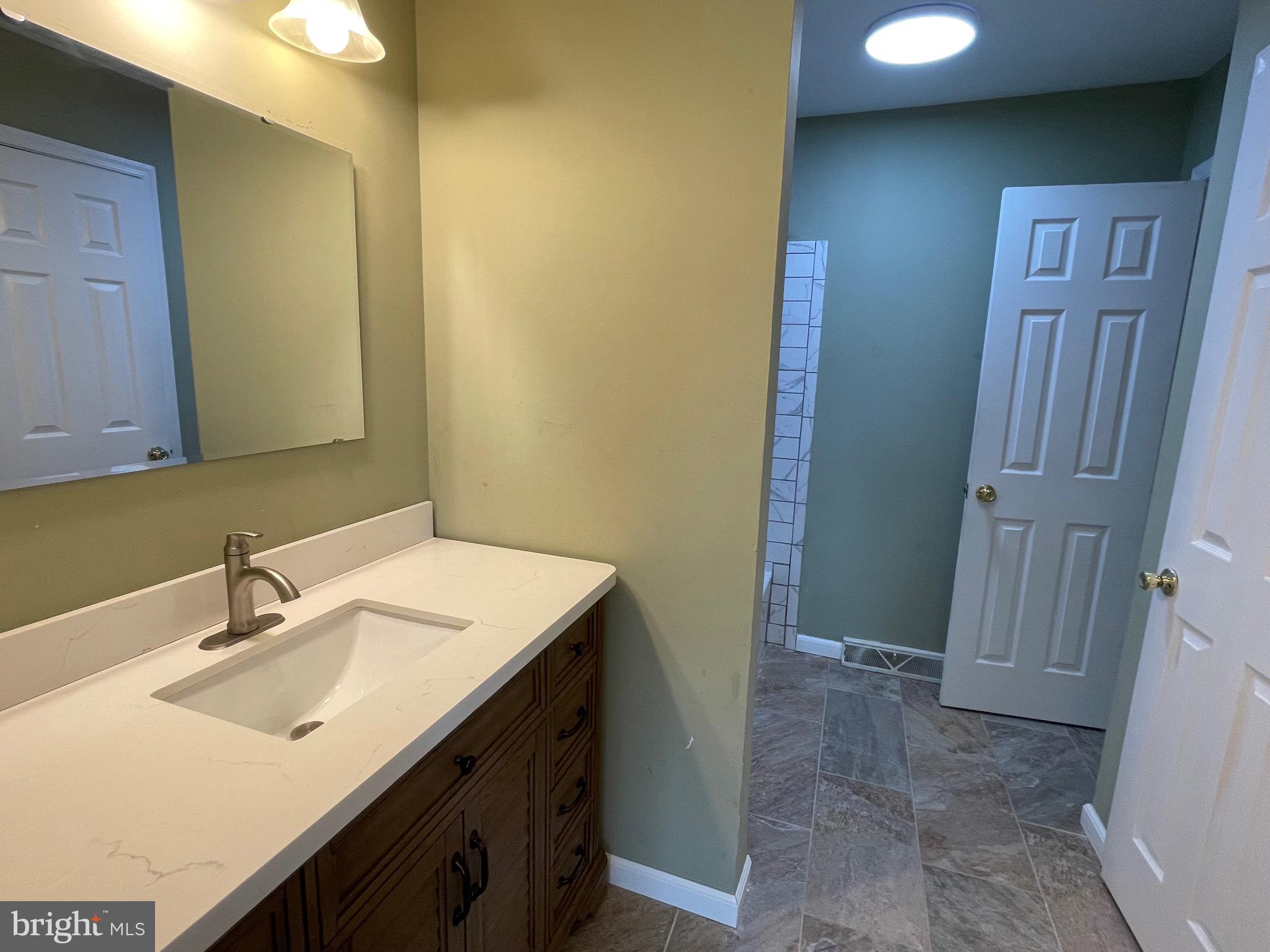 3314 Roxbury Road Hatfield, PA 19440 - Photo 14 of 26 a bathroom with a sink and a mirror