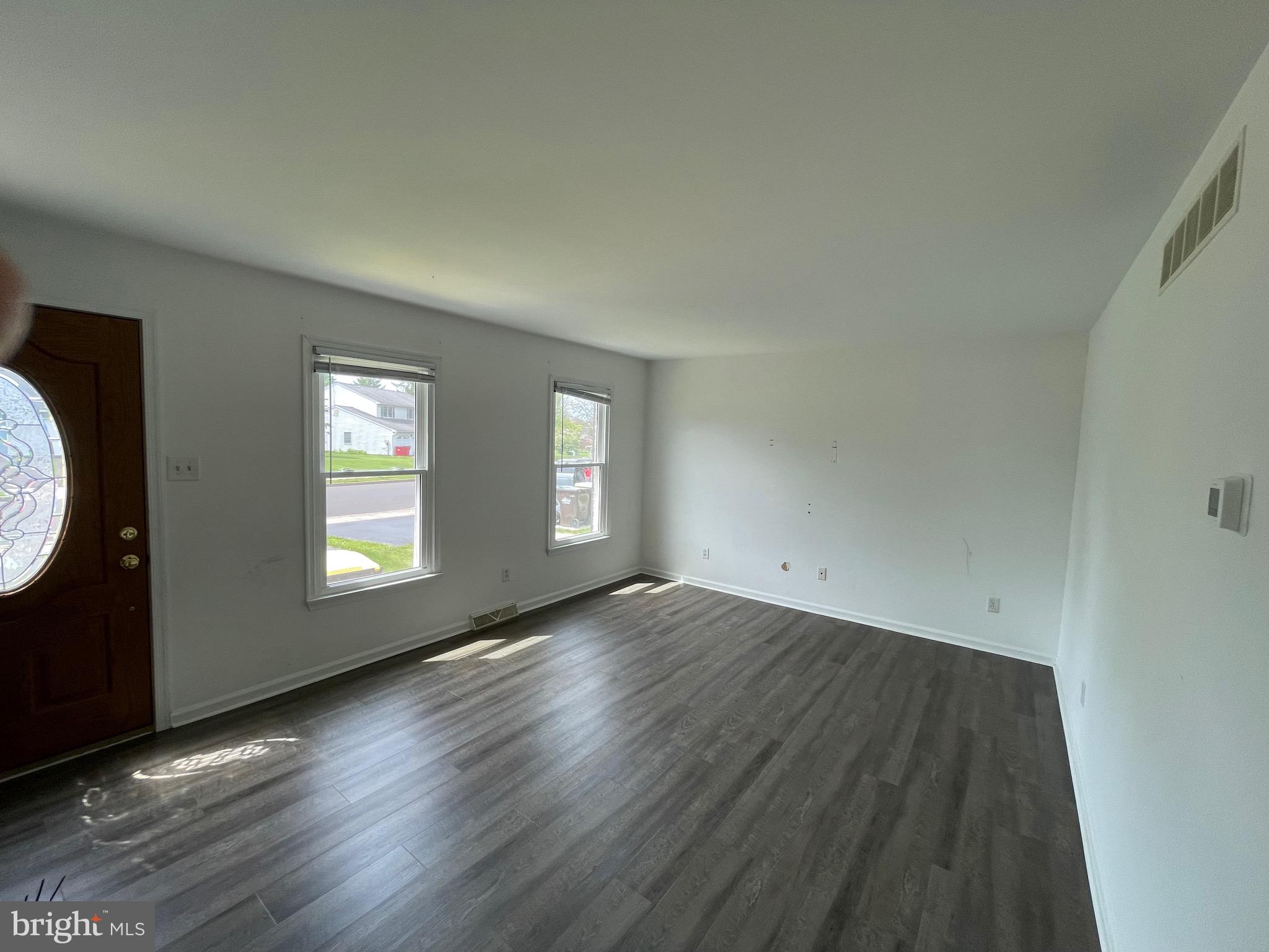 3314 Roxbury Road Hatfield, PA 19440 - Photo 4 of 26 an empty room with wooden floor and windows