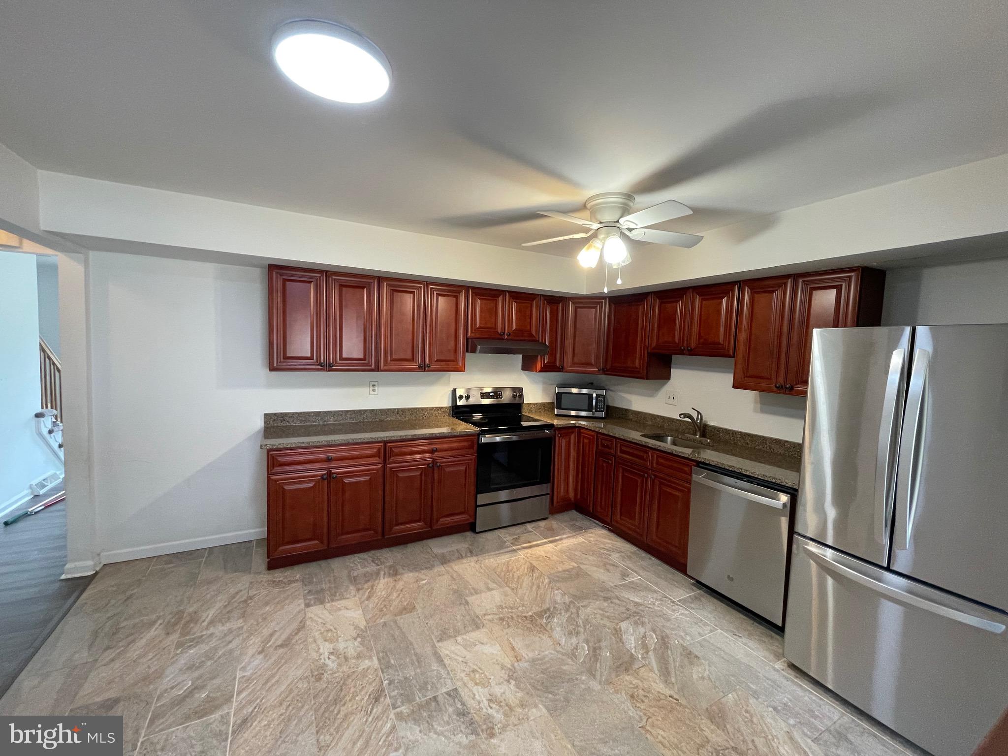 3314 Roxbury Road Hatfield, PA 19440 - Photo 7 of 26 a large kitchen with granite countertop a refrigerator stove top oven and cabinets