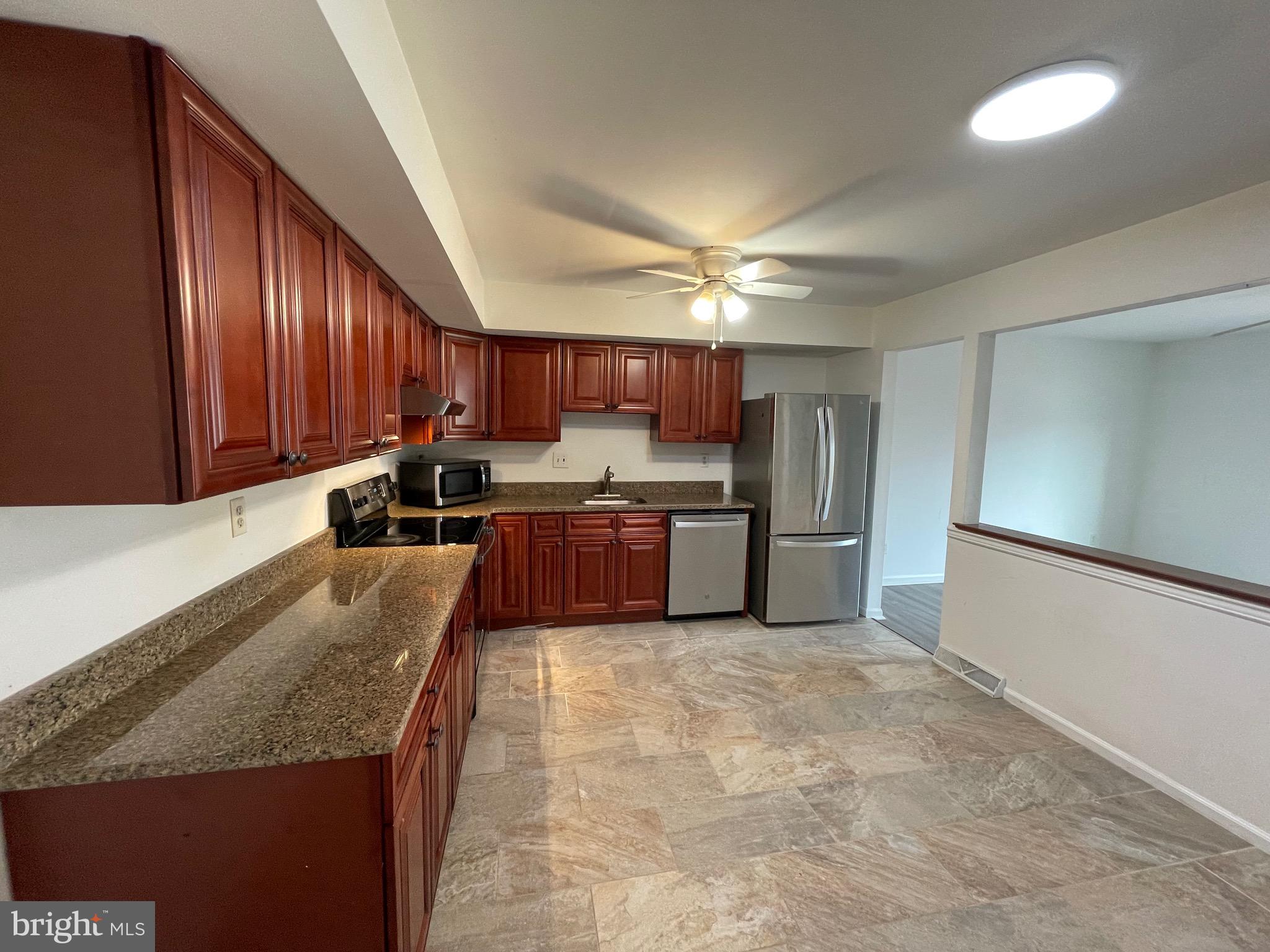 3314 Roxbury Road Hatfield, PA 19440 - Photo 10 of 26 a large kitchen with stainless steel appliances granite countertop a sink refrigerator and cabinets
