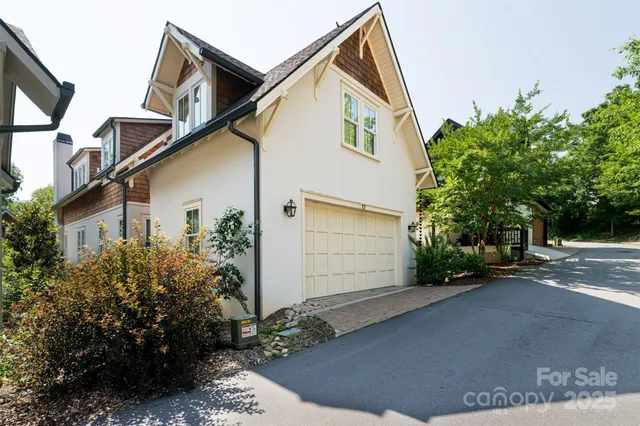 a view of a white house with a street