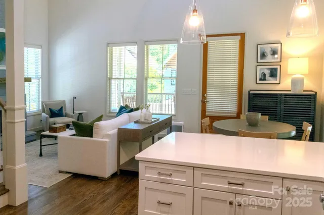 a living room with furniture and large windows