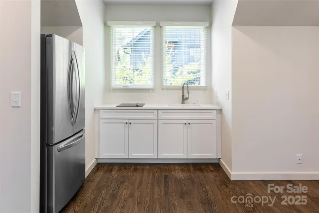 a kitchen with a refrigerator a sink and a window