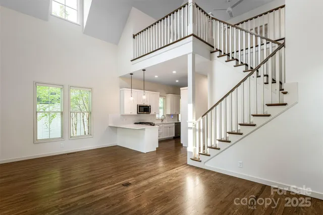 a view of entryway and hall with wooden floor