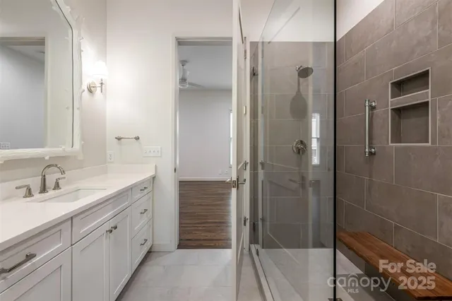 a spacious bathroom with a shower sink and mirror