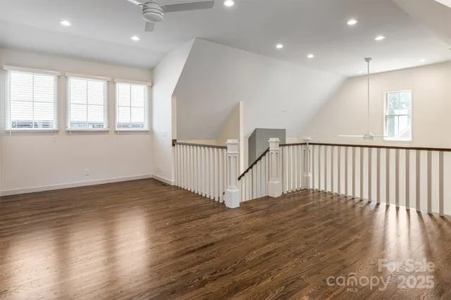a view of staircase with wooden floor and window