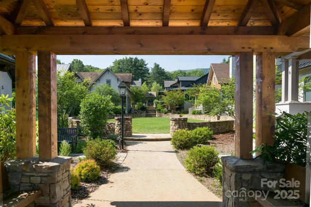 a view of a patio with table and chairs potted plants