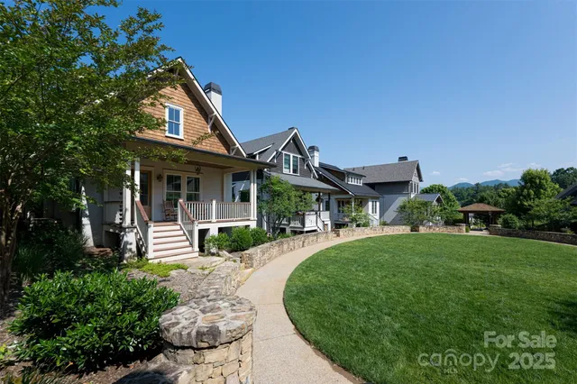 a front view of a house with a yard table and chairs