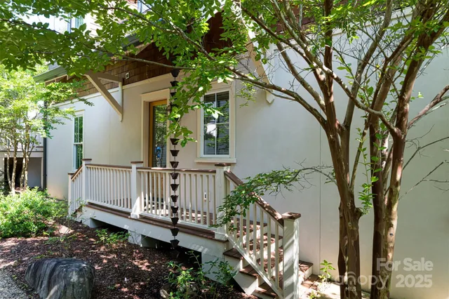 a view of a house with a yard and wooden fence