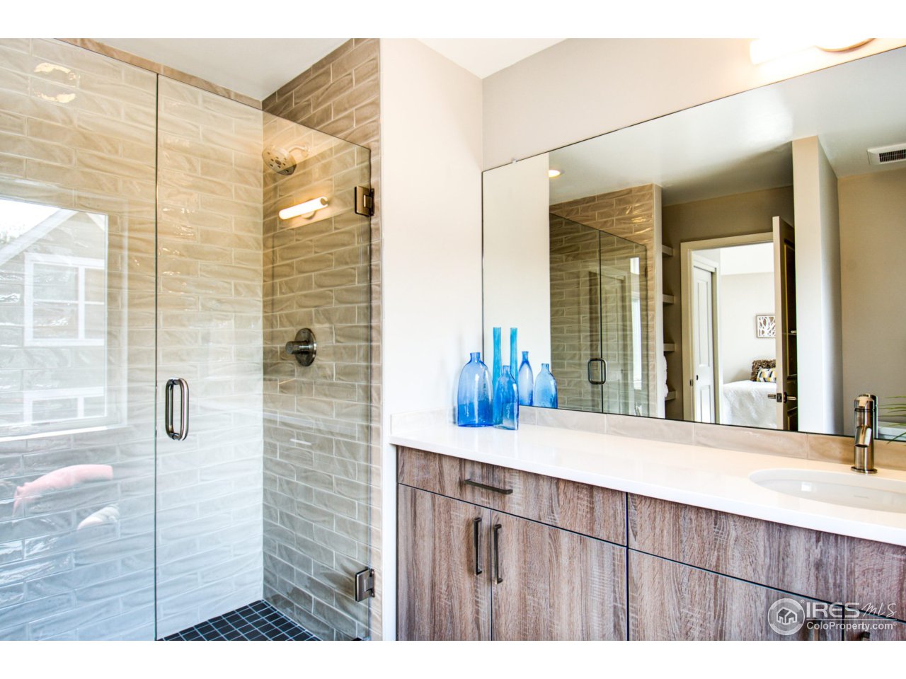 3959 Springleaf Lane Boulder, CO 80304 - Photo 18 of 25 a bathroom with a granite countertop sink and a mirror
