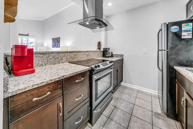 a kitchen with stainless steel appliances granite countertop a sink stove and cabinets
