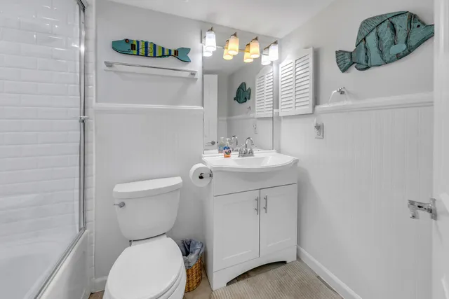 a bathroom with a glass shower door