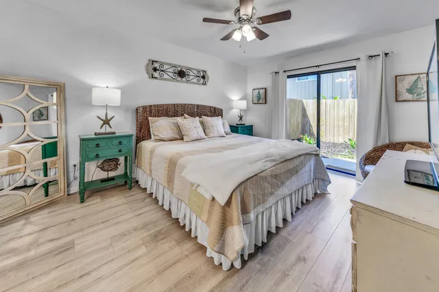 a spacious bedroom with a bed and a flat screen tv