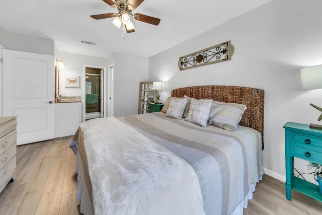 a bathroom with a granite countertop sink toilet mirror and bathtub