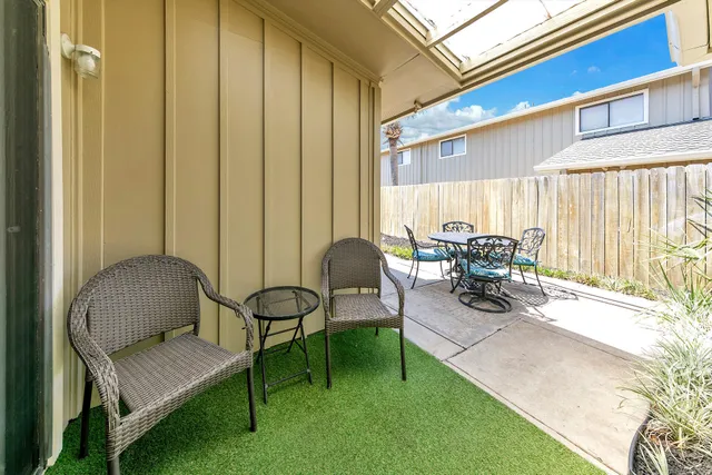 a building outdoor space with patio furniture and potted plants