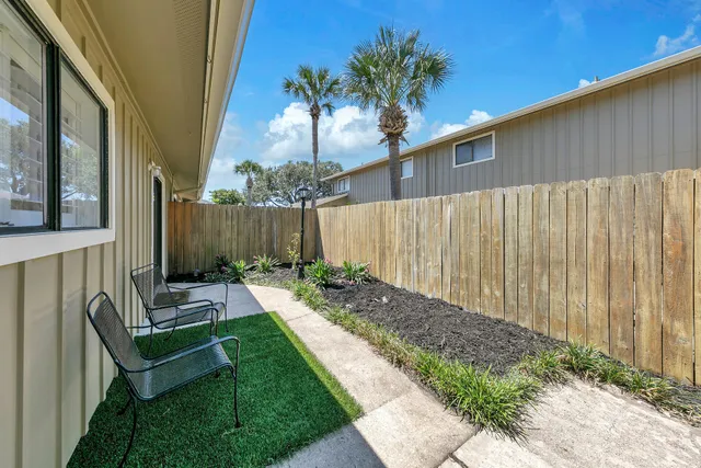 a view of a patio with table and chairs and potted plants