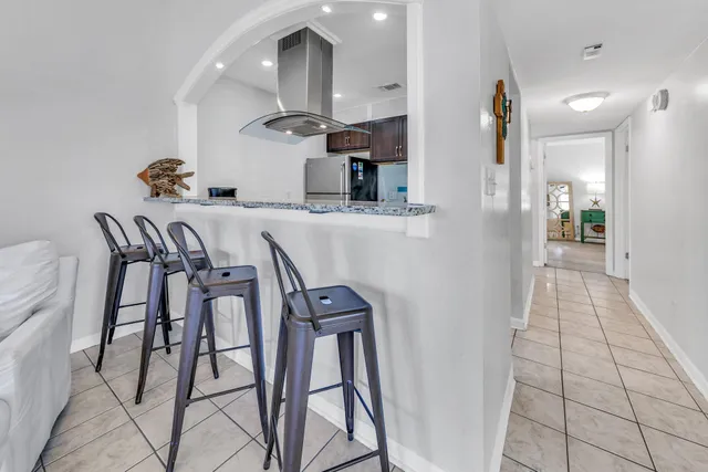 a kitchen with stainless steel appliances granite countertop a stove a refrigerator and a counter space