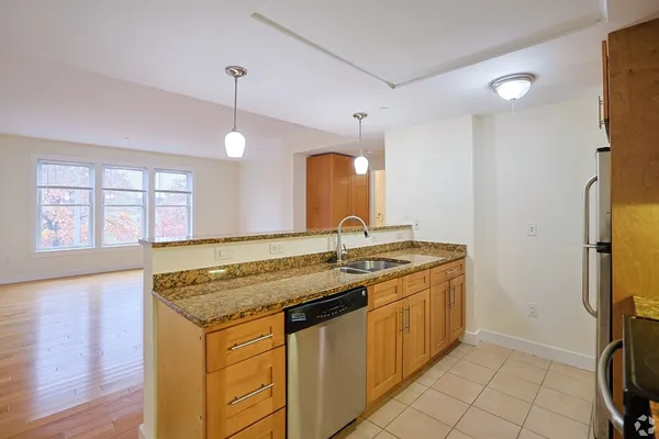 a kitchen with a sink stove and cabinets