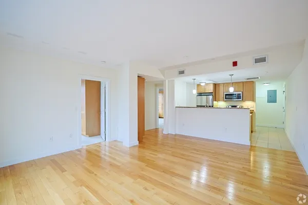 a view of a kitchen with wooden floor and a kitchen