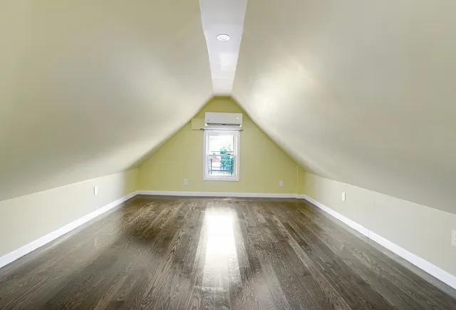 a view of an empty room and wooden floor
