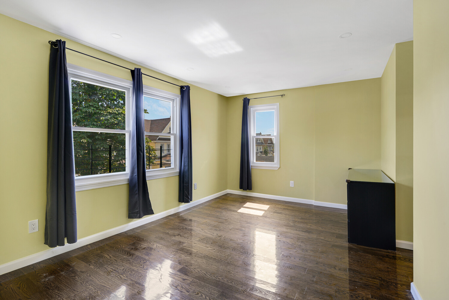 144-38 87th Avenue, Unit 2 Queens, NY 11435 - Photo 6 of 14 a view of an empty room with glass door