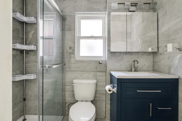 a bathroom with a toilet a sink and shower