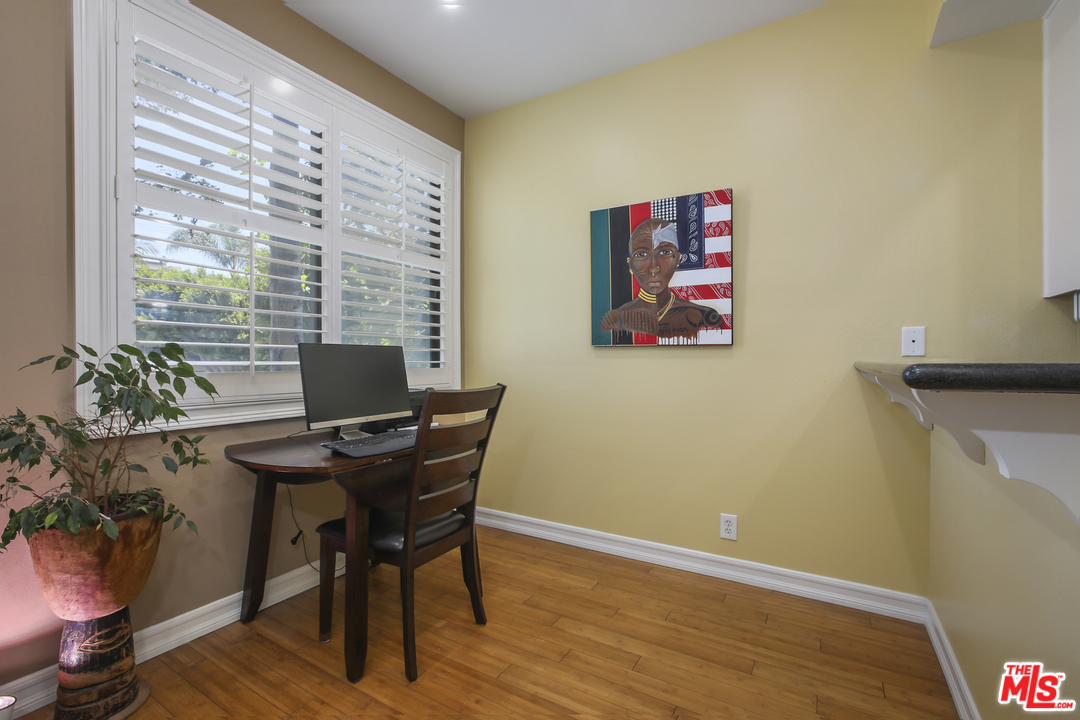 8110 Manitoba Street, Unit 104 Playa del Rey, CA 90293 - Photo 2 of 17 a view of a workspace with furniture and a potted plant