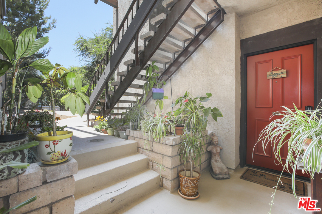 8110 Manitoba Street, Unit 104 Playa del Rey, CA 90293 - Photo 17 of 17 a view of a porch with chairs and potted plants