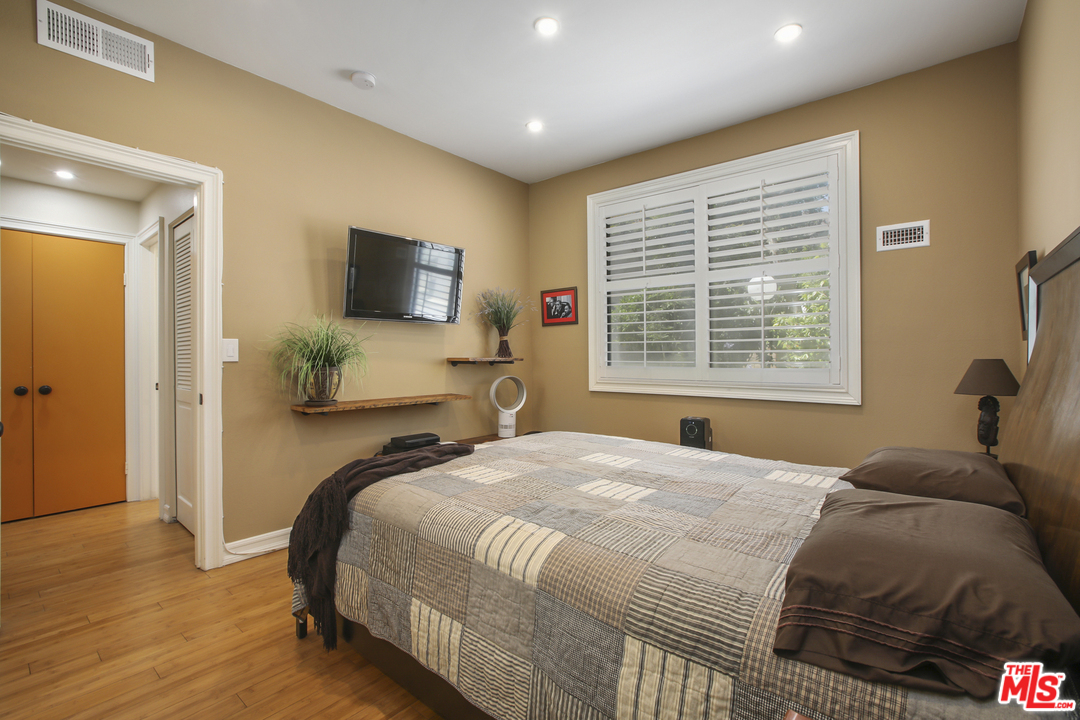 8110 Manitoba Street, Unit 104 Playa del Rey, CA 90293 - Photo 7 of 17 a bedroom with a bed and a flat screen tv
