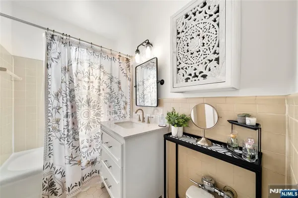 a bathroom with a sink mirror vanity and toilet