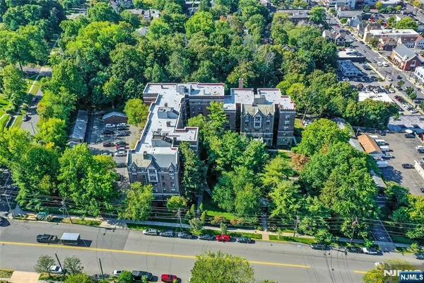 an aerial view of a house with a garden and trees