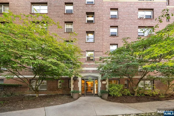 front view of a brick house with a large windows