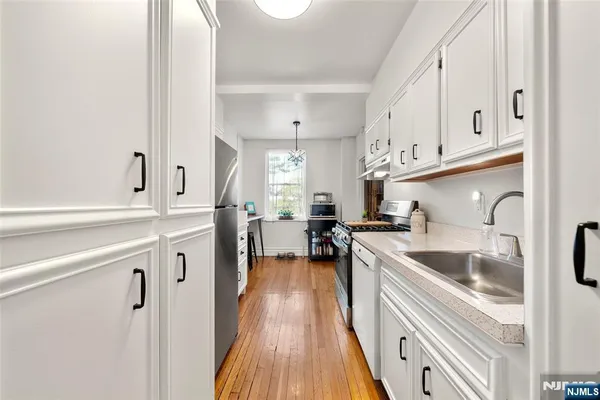 a kitchen with cabinets a sink and appliances