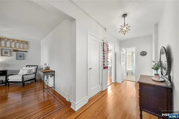 a view of a livingroom with furniture wooden floor and a chandelier
