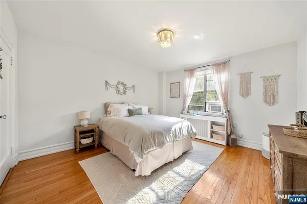 a spacious bedroom with a bed and a window