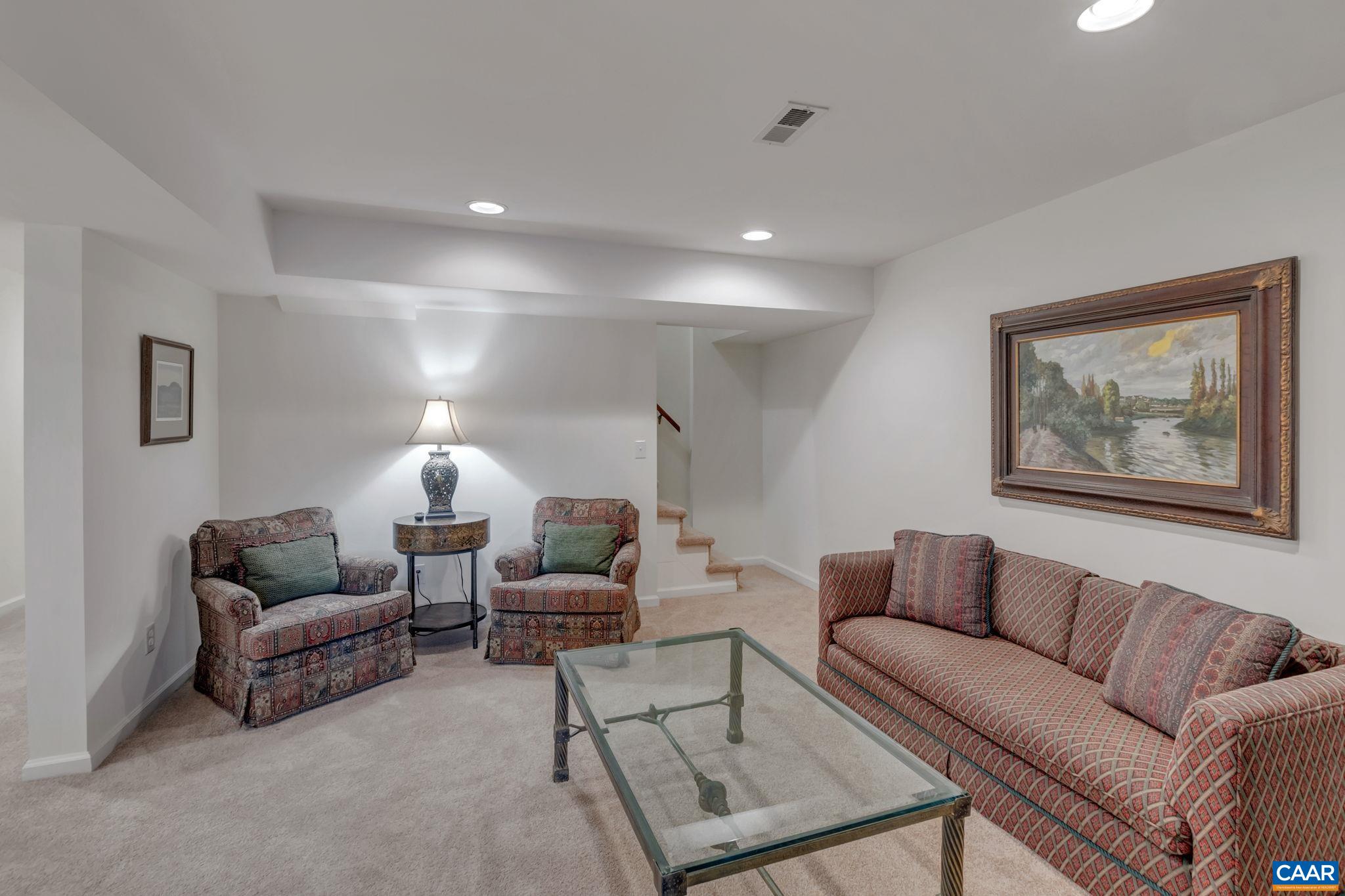1815 Winston Road Charlottesville, VA 22903 - Photo 42 of 65 a living room with furniture ceiling fan and a lamp